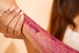 Hand applying pink powder dor radiant skin image on padma home page